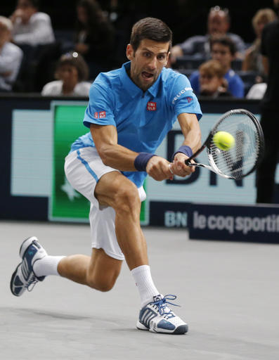 Novak Djokovic of Serbia returns the ball to Grigor Dimitrov of Bulgaria during the 3rd round of the Paris Masters tennis tournament at the Bercy Arena in Paris, Thursday, Nov. 3, 2016. Djokovic won 4-6, 6-2, 6-3. (AP Photo/Michel Euler)