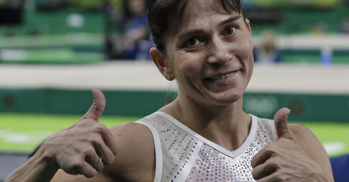 Uzbekistan's Oksana Chusovitina acknowledges the audience after her routine on the balance beam during the artistic gymnastics women's qualification at the 2016 Summer Olympics in Rio de Janeiro, Brazil, Sunday, Aug. 7, 2016. (AP Photo/Rebecca Blackwell)