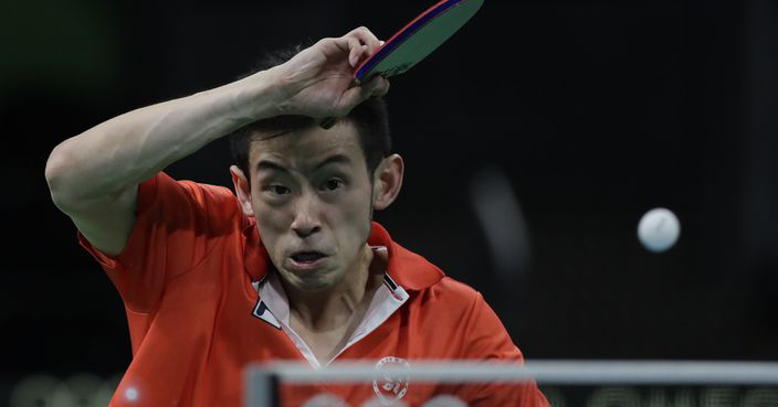 Wong Chun Ting of Hong Kong hits a forehand as he plays Ho Kwan Kit of Hong Kong against Heming Hu and Xin Yan of Australia during their men's team table tennis quarter final match at the 2016 Summer Olympics in Rio de Janeiro, Brazil, Saturday, Aug. 13, 2016. (AP Photo/Petros Giannakouris)