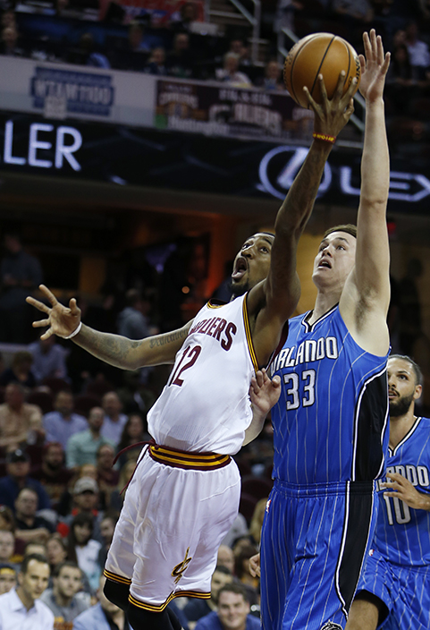 Cleveland Cavaliers' Jordan McRae (12) goes up for a shot against Orlando Magic's Stephen Zimmerman (33) during the first half of an NBA preseason basketball game Wednesday, Oct. 5, 2016, in Cleveland. (AP Photo/Ron Schwane)