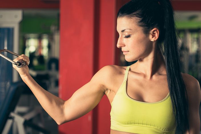 Beautiful fit woman working out in gym girl in fitness