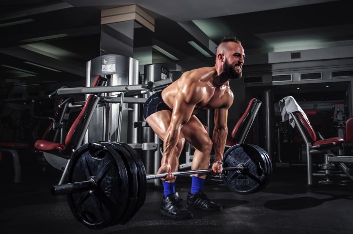 Muscular Man Doing Heavy Deadlift Exercise