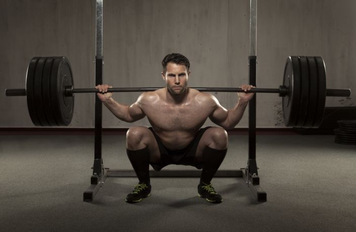 Athlete performing squat with barbell