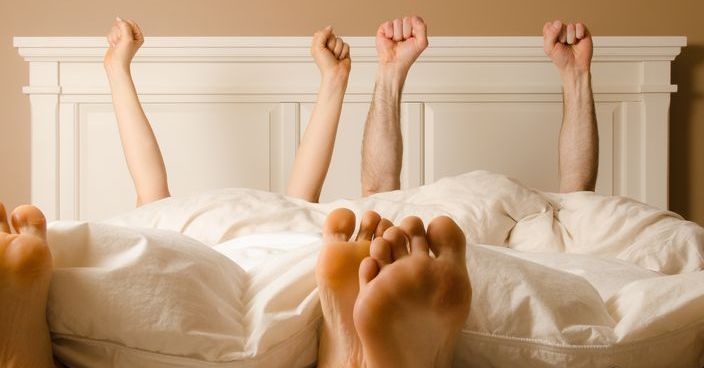 image of a couple celebrating in bed