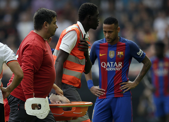 FC Barcelona's Andes Iniesta is stretchered off after an injury during the Spanish La Liga soccer match between Valencia and FC Barcelona at the Mestalla stadium in Valencia, Spain, Saturday, Oct. 22, 2016. (AP Photo/Manu Fernandez)