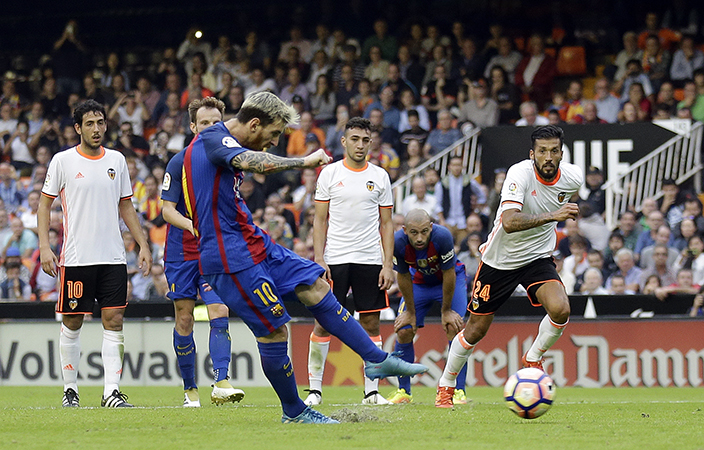 FC Barcelona's Lionel Messi kicks for the ball to score a penalty during the Spanish La Liga soccer match between Valencia and FC Barcelona at the Mestalla stadium in Valencia, Spain, Saturday, Oct. 22, 2016. (AP Photo/Manu Fernandez)