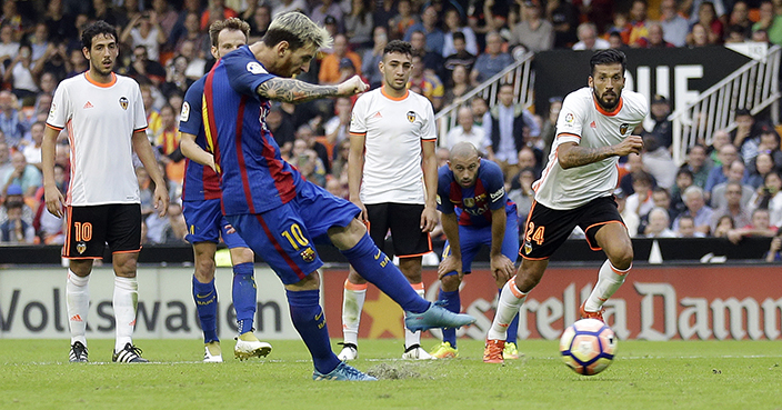 FC Barcelona's Lionel Messi kicks for the ball to score a penalty during the Spanish La Liga soccer match between Valencia and FC Barcelona at the Mestalla stadium in Valencia, Spain, Saturday, Oct. 22, 2016. (AP Photo/Manu Fernandez)