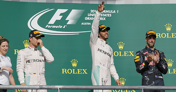 Mercedes driver Lewis Hamilton, center, of Britain, celebrates after winning the Formula One U.S. Grand Prix auto race at the Circuit of the Americas, Sunday, Oct. 23, 2016, in Austin, Texas. (AP Photo/Tony Gutierrez)