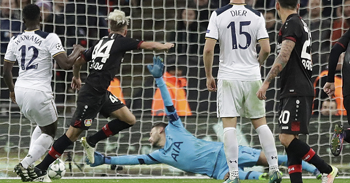 Leverkusen's Kevin Kampl, left, scores past by Tottenham's goalkeeper Hugo Lloris the opening goal during the Group E Champions League soccer match between Tottenham Hotspur and Bayer Leverkusen at the Wembley stadium in London, Wednesday, Nov. 2, 2016. (AP Photo/Matt Dunham)