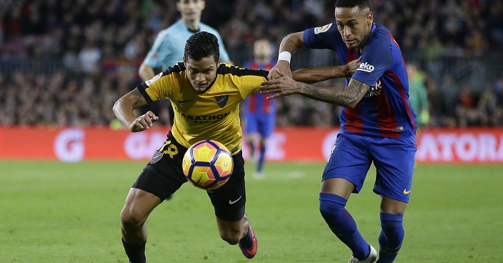 FC Barcelona's Neymar, right, duels for the ball against Malaga's Roberto Rosales during the Spanish La Liga soccer match between FC Barcelona and Malaga at the Camp Nou in Barcelona, Spain, Saturday, Nov. 19, 2016. (AP Photo/Manu Fernandez)