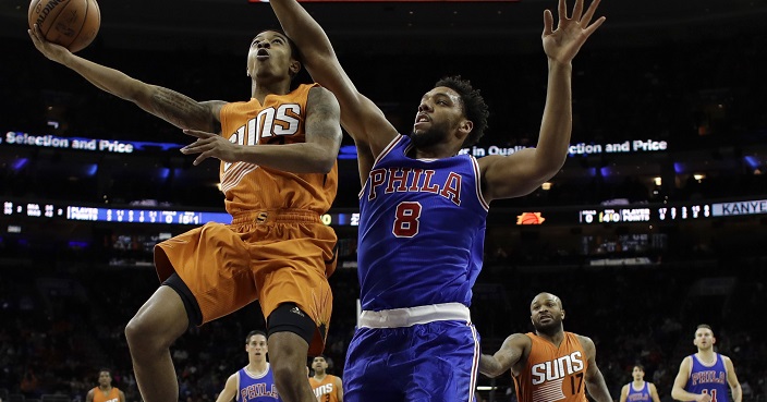 Phoenix Suns' Tyler Ulis, left, goes up for a shot adjacent to Philadelphia 76ers' Jahlil Okafor during the first half of an NBA basketball game, Saturday, Nov. 19, 2016, in Philadelphia. (AP Photo/Matt Slocum)