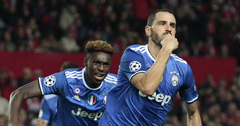 Juventus' Leonardo Bonucci, right, and Juventus' Moise Kean celebrate after Bonucci scored 1-2 during the Group H Champions League soccer match between Sevilla and Juventus at the Ramon Sanchez-Pizjuan stadium in Seville, Spain, Tuesday Nov. 22, 2016. (AP Photo/Miguel Morenatti)