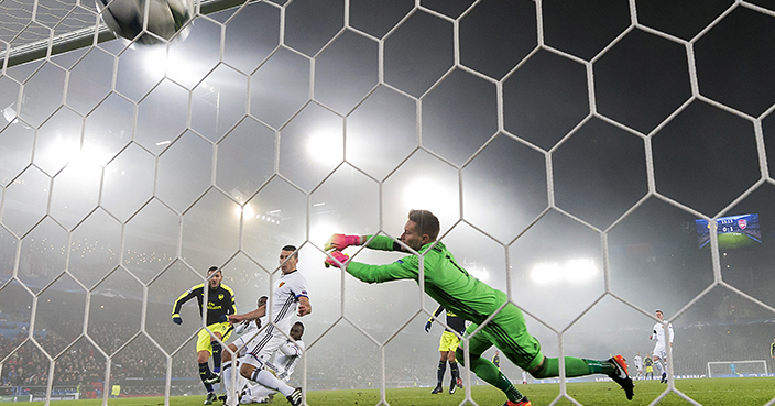 Arsenal's Lucas Perez, left, scores against Basel during their Champions League Group stage Group A soccer match between Switzerland's FC Basel 1893 and England's Arsenal FC in the St. Jakob-Park stadium in Basel, Switzerland, on Tuesday, Dec. 6, 2016. (Georgios Kafalas/Keystone via AP)