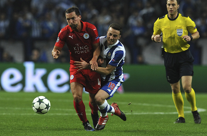 Referee Felix Zwayer watches as Porto's Diogo Jota collides with Leicester's Danny Drinkwater, left, during a Champions League group G soccer match between FC Porto and Leicester City at the Dragao stadium in Porto, Portugal, Wednesday, Dec. 7, 2016. (AP Photo/Paulo Duarte)