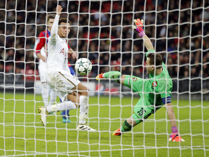 Tottenham's Dele Alli, left, scores his side's 3rd goal past CSKA goalkeeper Igor Akinfeev during the Champions League group E soccer match between Tottenham Hotspur and CSKA Moscow at Wembley stadium in London, Wednesday, Dec. 7, 2016. (AP Photo/Frank Augstein)