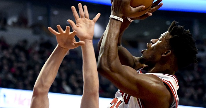 Chicago Bulls forward Jimmy Butler (21) shoots against Brooklyn Nets guard Bojan Bogdanovic, left, during the first half of an NBA basketball game Wednesday, Dec. 28, 2016, in Chicago. (AP Photo/Matt Marton)