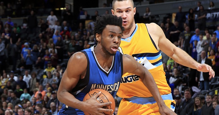 Minnesota Timberwolves forward Andrew Wiggins (22) drives past Denver Nuggets forward Danilo Gallinari (8) during the first half of an NBA basketball game Wednesday, Dec. 28, 2016, in Denver. (AP Photo/Jack Dempsey)