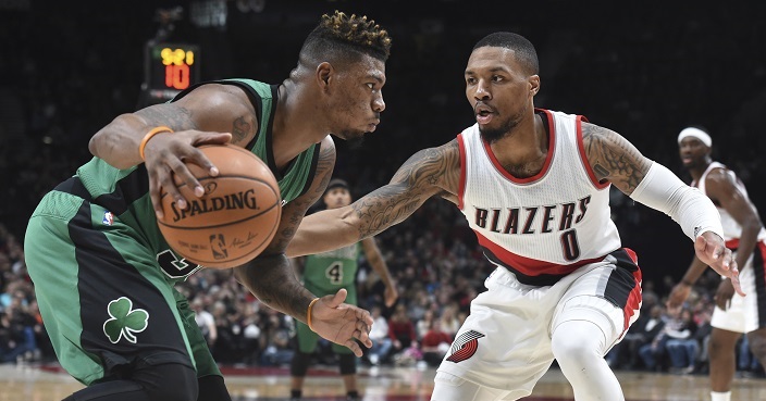 Boston Celtics guard Marcus Smart tries to get past Portland Trail Blazers guard Damian Lillard during the first half of an NBA basketball game in Portland, Ore., Thursday, Feb. 9, 2017. (AP Photo/Steve Dykes)