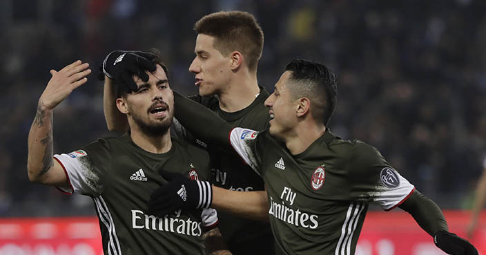 AC Milan's Suso, left, celebrates with teammates after scoring a goal during an Italian Serie A soccer match between Lazio and Milan, at the Olympic stadium in Rome, Monday, Feb. 13, 2017. (AP Photo/Gregorio Borgia)