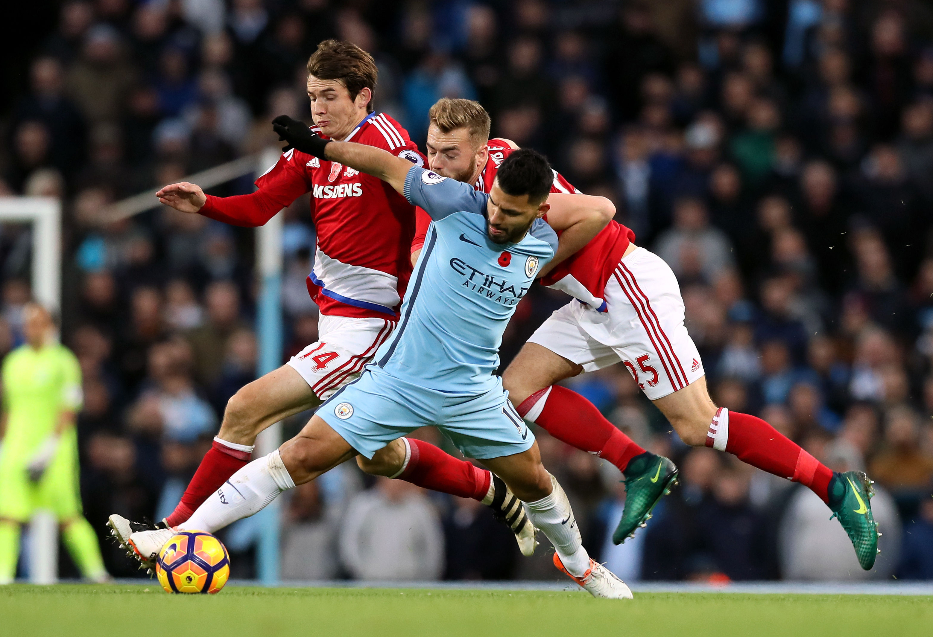 Manchester City's Sergio Aguero reaches for the ball with Middlesbrough's Marten de Roon, left, and Calum Chambers, right, during their English Premier League soccer match at the Etihad Stadium, Manchester, England, Saturday Nov. 5, 2016. (Martin Rickett / PA via AP)