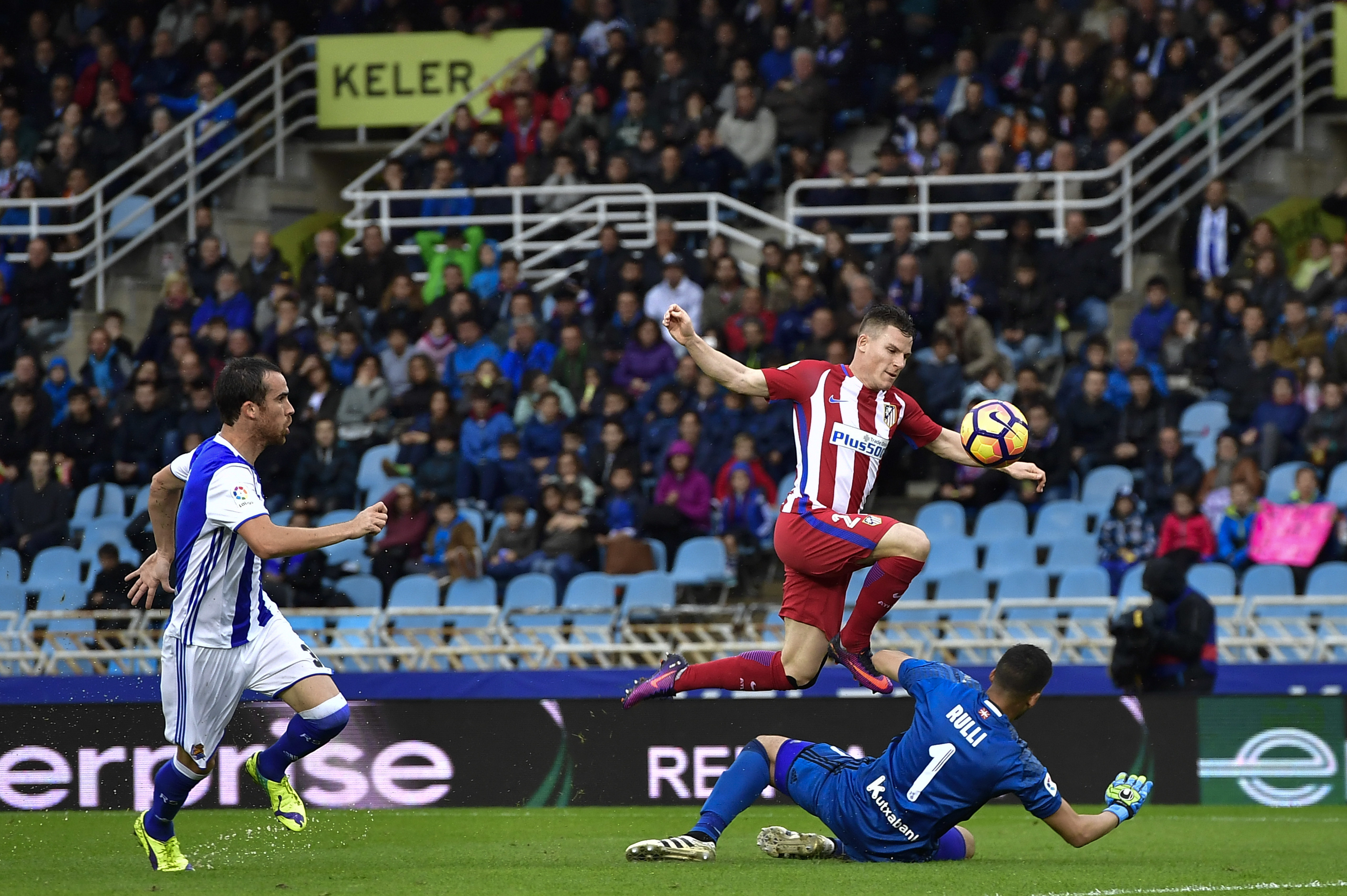 Atletico de Madrid's Kevin Gameiro, jumps over Real Sociedad's goalkeeper Geronimo Rulli during the Spanish La Liga soccer match between Real Madrid and Real Sociedad, at Anoeta stadium, in San Sebastian, northern Spain, Saturday, Nov.5, 2016. (AP Photo/Alvaro Barrientos)