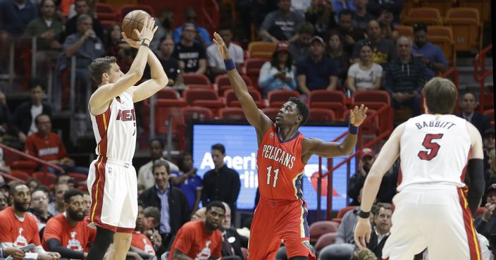 Miami Heat guard Goran Dragic (7) prepares to shoot over New Orleans Pelicans guard Jrue Holiday (11) in the first half of an NBA basketball game, Wednesday, March 15, 2017, in Miami. (AP Photo/Alan Diaz)