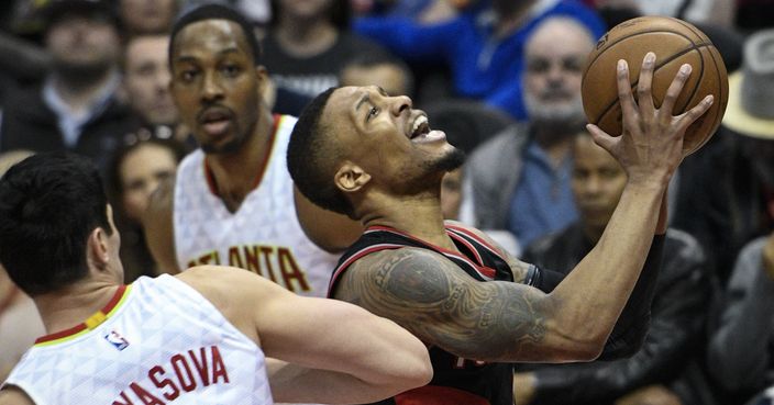 Portland Trail Blazers guard Damian Lillard goes to the basket past the defense of Atlanta Hawks forward Ersan Ilyasova (7) during the second half of an NBA basketball game, Saturday, March 18, 2017, in Atlanta. Portland won 113-97.  (AP Photo/John Amis)