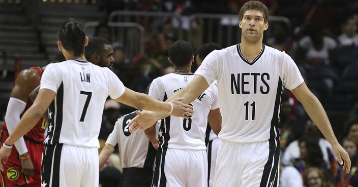 Brooklyn Nets' Jeremy Lin, left, gets congratulations from Brook Lopez after scoring against the Atlanta Hawks during an NBA basketball game Sunday, March 26, 2017, in Atlanta. The Nets won 107-92. (Curtis Compton/Atlanta Journal-Constitution via AP)