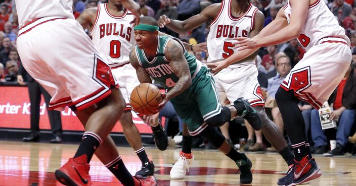 Boston Celtics' Isaiah Thomas (4) dribbles through the Chicago Bulls defense of Cristiano Felicio (6) Isaiah Canaan (0) Bobby Portis (5) and Paul Zipser during the first half in Game 4 of an NBA basketball first-round playoff series in Chicago, Sunday, April 23, 2017. (AP Photo/Charles Rex Arbogast)