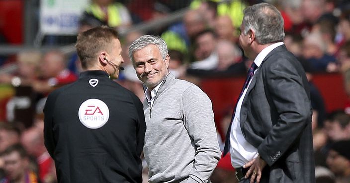 Manchester United manager Jose Mourinho, centre reacts with Crystal Palace manager Sam Allardyce, right, during the English Premier League soccer match between Manchester United and Crystal Palace, at Old Trafford, in Manchester, England, Sunday, May 21, 2017. (Martin Rickett/PA via AP)