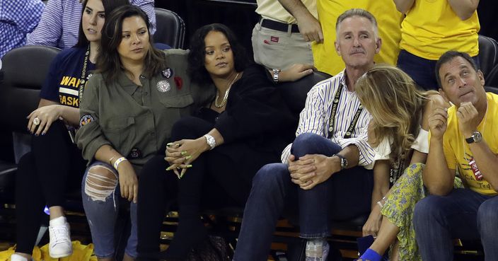 Singer Rihanna, second from left, watches Game 1 of basketball's NBA Finals between the Golden State Warriors and the Cleveland Cavaliers Thursday, June 1, 2017, in Oakland, Calif. (AP Photo/Marcio Jose Sanchez)