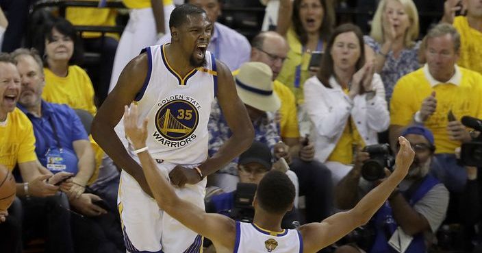 Golden State Warriors forward Kevin Durant (35) celebrates with guard Stephen Curry (30) during the second half of Game 2 of basketball's NBA Finals against the Cleveland Cavaliers in Oakland, Calif., Sunday, June 4, 2017. (AP Photo/Marcio Jose Sanchez)