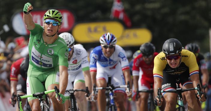 Germany's Marcel Kittel, wearing the best sprinter's green jersey, left, crosses the finish line ahead of second placed Dylan Groenewegen of the Netherlands, right, to win the eleventh stage of the Tour de France cycling race over 203.5 kilometers (126.5 miles) with start in Eymet and finish in Pau, France, Wednesday, July 12, 2017. (AP Photo/Christophe Ena)