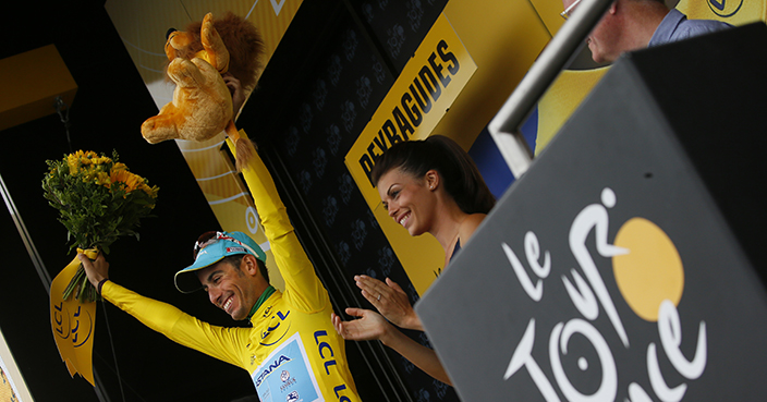 Italy's Fabio Aru, wearing the overall leader's yellow jersey, celebrates on the podium after the twelfth stage of the Tour de France cycling race over 214.5 kilometers (133.3 miles) with start in Pau and finish in Peyragudes, France, Thursday, July 13, 2017. (AP Photo/Peter Dejong)