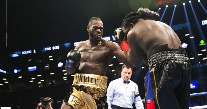 Deontay Wilder connects with Bermane Stiverne during the WBC Heavyweight World Championship fight Saturday, Nov. 4, 2017, in New York. Wilder knocked out Stiverne early in the first round. (AP Photo/Kevin Hagen)