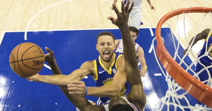 Golden State Warriors' Stephen Curry, top, shoots as Philadelphia 76ers' Joel Embiid, of Cameroon, bottom, defends during the second half of an NBA basketball game Saturday, Nov. 18, 2017, in Philadelphia. The Warriors won 124-116. (AP Photo/Chris Szagola)