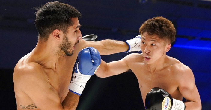 Champion Naoya Inoue, right, of Japan fights with challenger Yaon Boyeaux of France in the first round of their WBO Super Flyweight world title match in Yokohama, near Tokyo, Saturday, Dec. 30, 2017. (AP Photo/Shizuo Kambayashi)