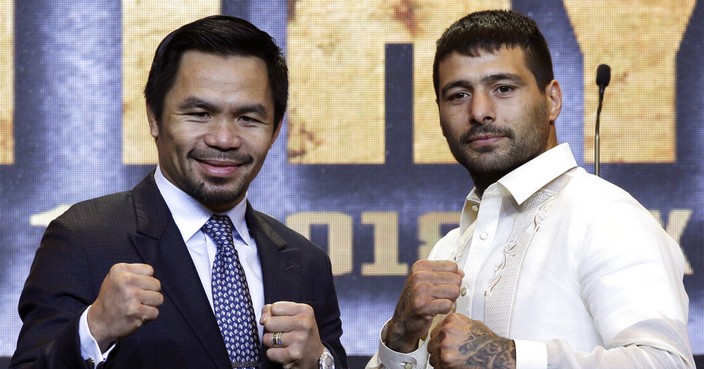 Philippine senator and boxing hero Manny Pacquiao, left, and Argentine WBA welterweight champion Lucas Matthysse pose for photographers during a press conference in Manila, Philippines on Wednesday, April 18, 2018. The two are scheduled to fight on July 15, in a World Boxing Association welterweight title fight in Malaysia. (AP Photo/Aaron Favila)