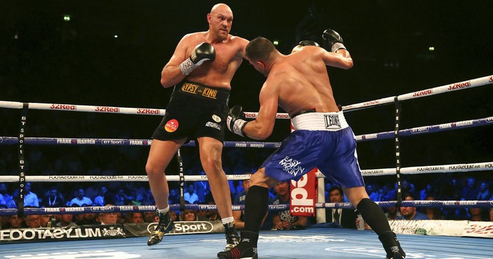 Britain's Tyson Fury, left, punches Sefer Seferi during their heavyweight bout at the Manchester Arena, in Manchester, England, Saturday June 9, 2018. (Nick Potts/ PA via AP)