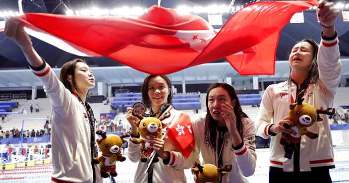 The Hong Kong women's 4x100m medley relay silver medalists pose for photographers during swimming competition at the 18th Asian Games in Jakarta, Indonesia, Thursday, Aug. 23, 2018. (AP Photo/Lee Jin-man)