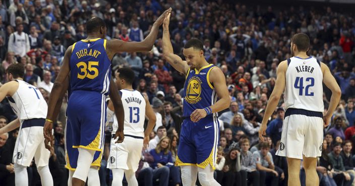 Golden State Warriors forward Kevin Durant (35) high-fives guard Stephen Curry (30) near the end of an NBA basketball game against the Dallas Mavericks, Sunday, Jan. 13, 2019, in Dallas. (AP Photo/Richard W. Rodriguez)