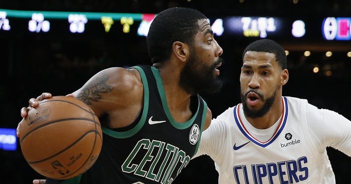 Boston Celtics' Kyrie Irving (11) drives past Los Angeles Clippers' Garrett Temple (17) during the first half of an NBA basketball game in Boston, Saturday, Feb. 9, 2019. (AP Photo/Michael Dwyer)