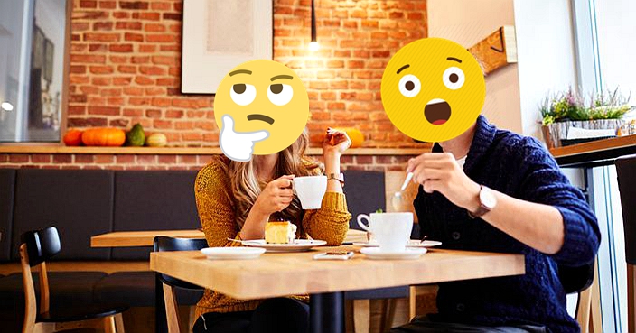 Couple of young people drinking coffee and eating cake in a stylish modern cafeteria