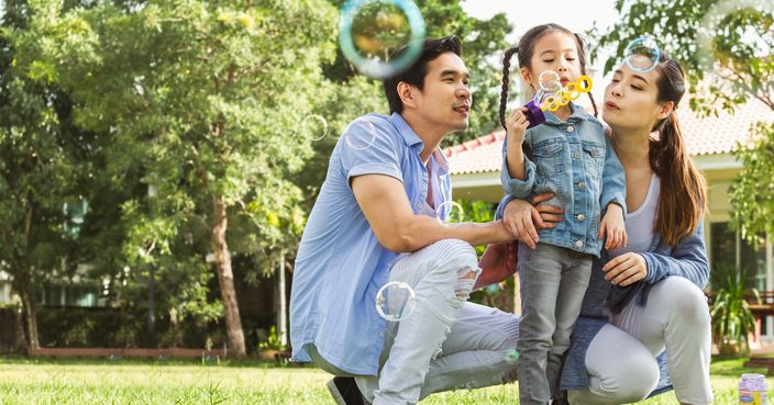 Happy Asian family playing in garden blowing bubble, happy and smile